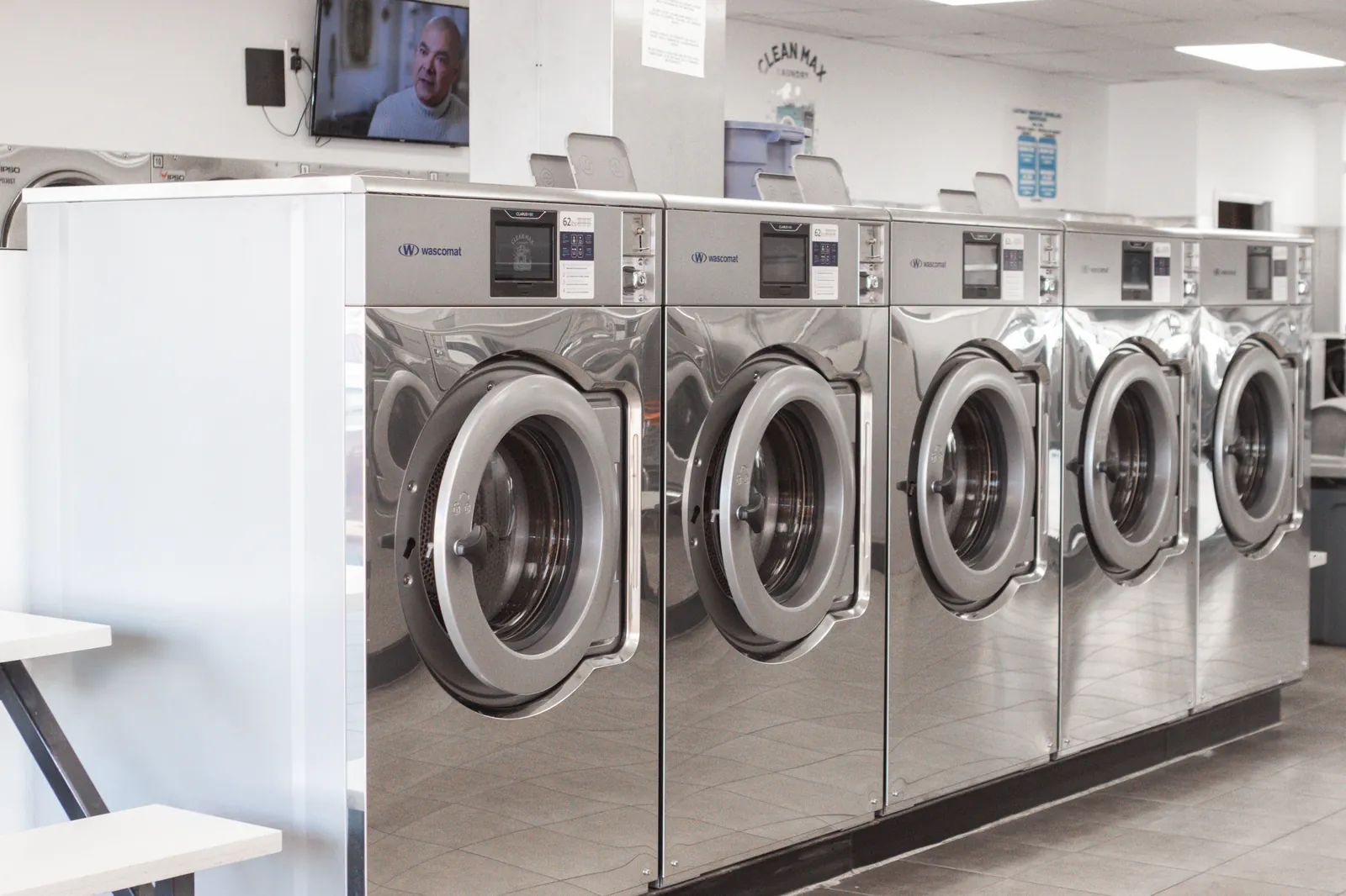 Row of Wascomat Clarus Vibe washing machines at CleanMax Laundromat in Pomona, CA